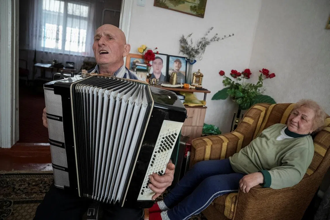 Petro Hurin, 76, one of hundreds of thousands of ‘liquidators’ brought to clean up the aftermath of the explosion that tore apart reactor Four of the Chornobyl nuclear plant in Ukraine on April 26, 1986, plays the accordion as his wife Olha listens in their house in the village of Khutory, Cherkasy region, Ukraine April 7, 2026.