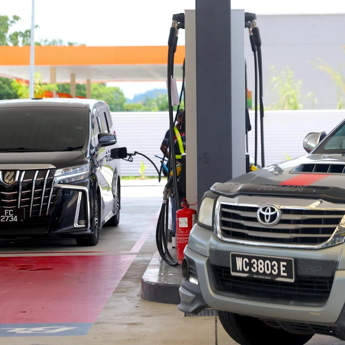 A vehicle is refilled at a petrol station in Port Dickson on March 25, 2026. The  government is spending about RM4 billion (S$1.28 billion) a month to absorb the surge in global oil prices following the outbreak of the Iran war on Feb 28. 