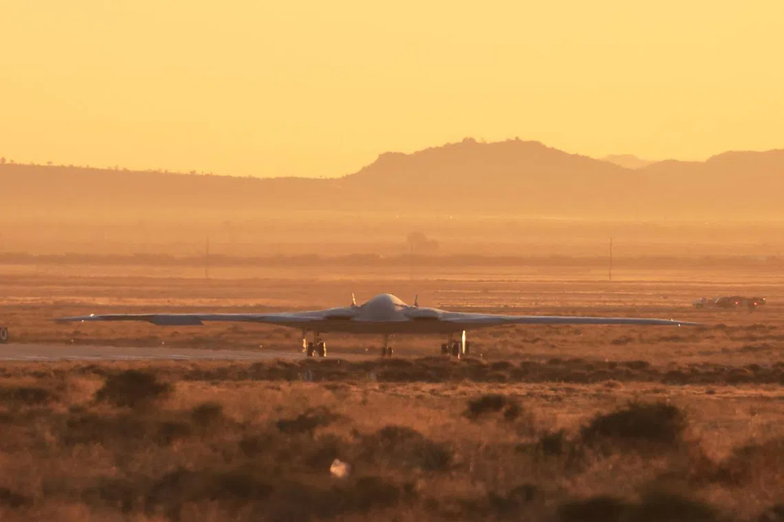 FILE PHOTO: The United States Air Force's B-21 \"Raider\", the long-range stealth bomber that can be armed with nuclear weapons, rolls onto the runway at Northrop Grumman's site at Air Force Plant 42, during its first flight, in Palmdale, California, U.S., November 10, 2023. REUTERS/David Swanson/File Photo