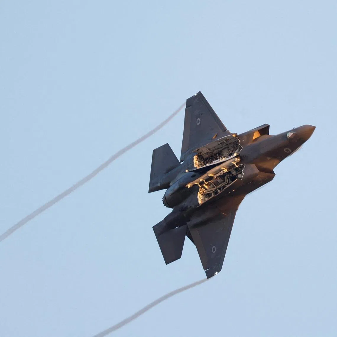 FILE PHOTO: A F-35 fighter jet flies with weapon bay doors open during a graduation ceremony for Israeli Air Force pilots at Hatzerim Airbase, in southern Israel, June 29, 2023. REUTERS/Amir Cohen/File Photo