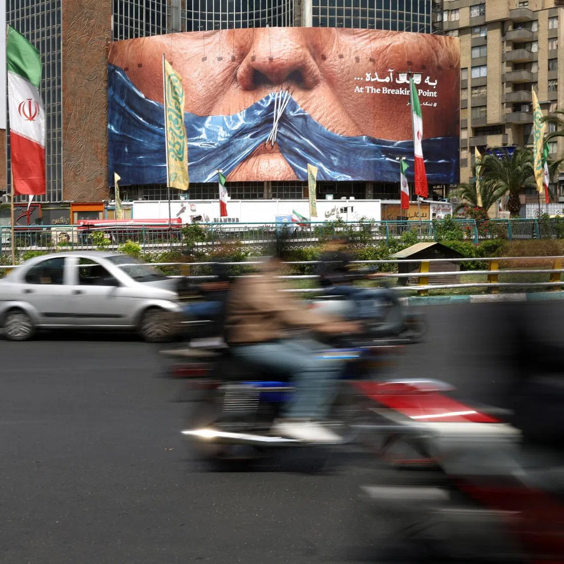 People drive past an anti-U.S. billboard depicting U.S. President Donald Trump and the Strait of Hormuz, in Tehran, Iran, May 2, 2026. Majid Asgaripour/WANA (West Asia News Agency) via REUTERS