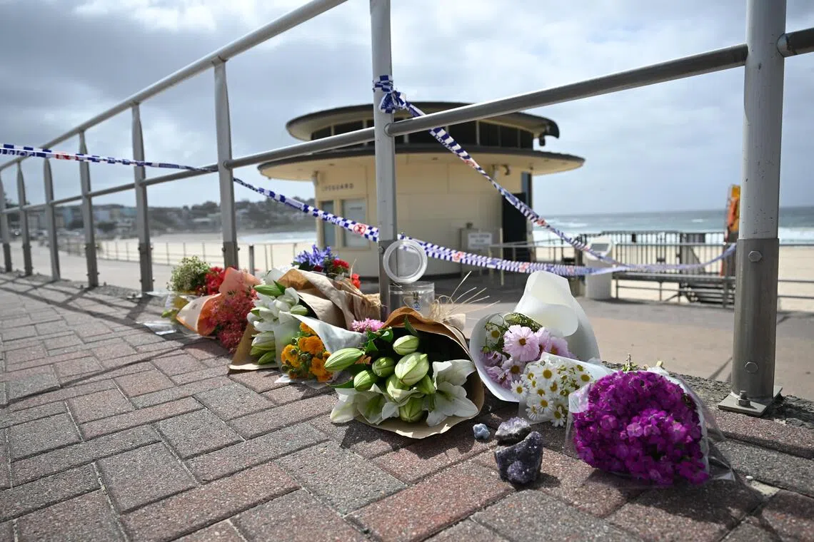 Flowers at the site where two gunmen opened fire at Bondi Beach in Sydney, Australia, on Dec 15, 2025.