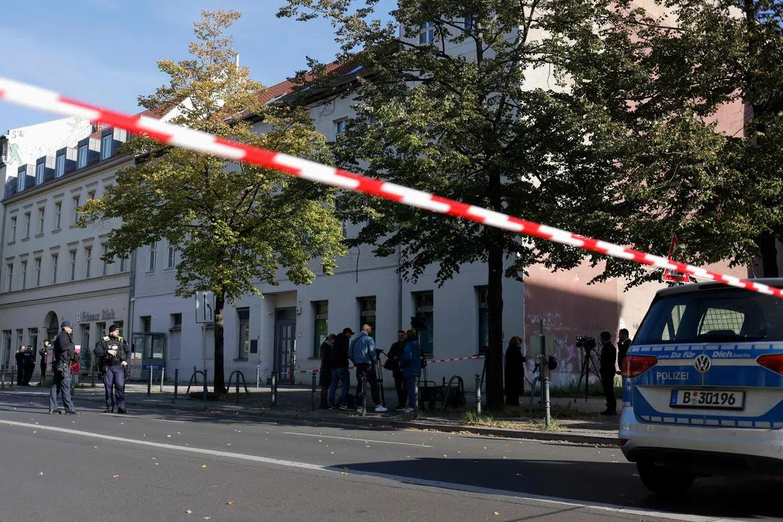 Police stand guard after assailants hurled two Molotov cocktails at a Jewish synagogue in Berlin.