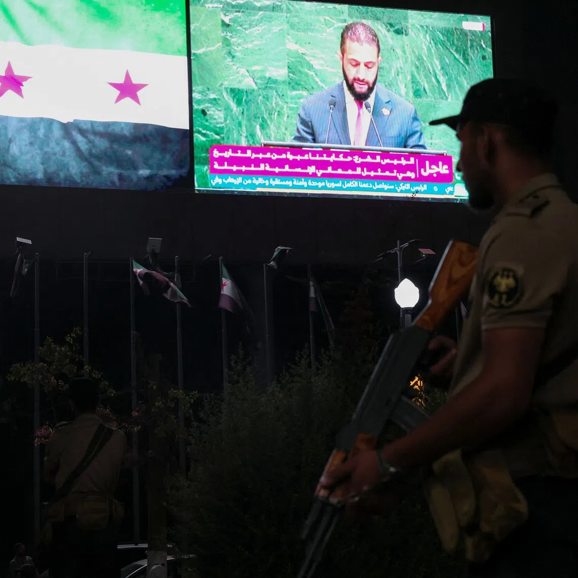 A member of the Syrian security forces stands during President Ahmad al-Sharaa's address at the United Nations General Assembly meeting, in Aleppo, Syria, Septemper 24, 2025. REUTERS/Mahmoud Hassano