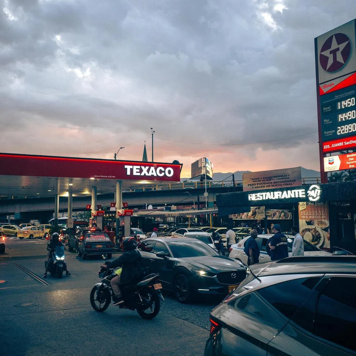 Vehicles line up at a Texaco petrol station during rush hour on  March 19, 2026, in the San Diego neighbourhood of Medellín, Colombia.