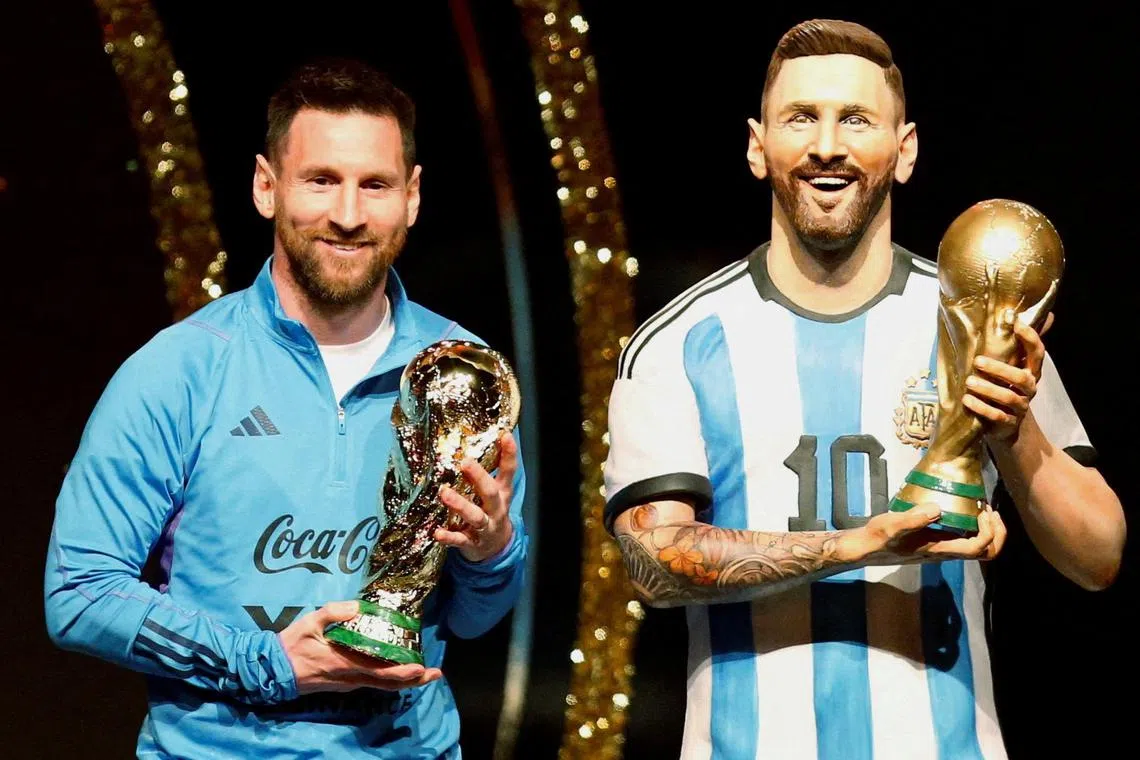 Argentina's Lionel Messi posing with the statue of himself holding the World Cup during the Conmebol event in Luque, Paraguay. 
