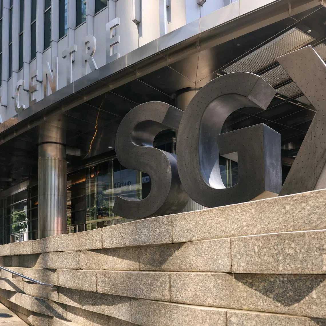 ST20250410_202564800364/pixgenerics/Brian Teo/A passer-by walking past the SGX logo outside SGX Centre on April 10, 2025. Can be used for stories on SGX, stock market, STI, Trump, tariffs, investment, Singapore index, recession, shares. ST PHOTO: BRIAN TEO