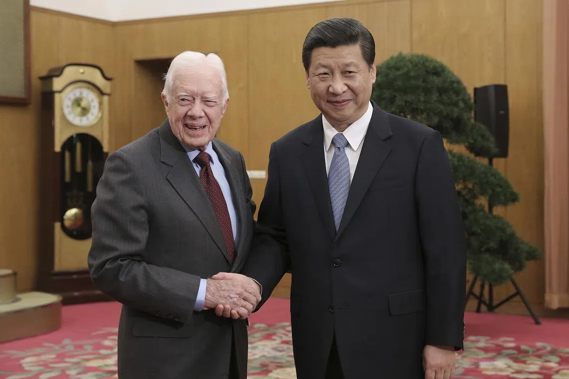 FILE PHOTO: China's Xi Jinping (R) shakes hands with former U.S. President Jimmy Carter during a meeting at  Zhongnanhai, the central government compound in Beijing, December 13, 2012. REUTERS/China Daily/File Photo