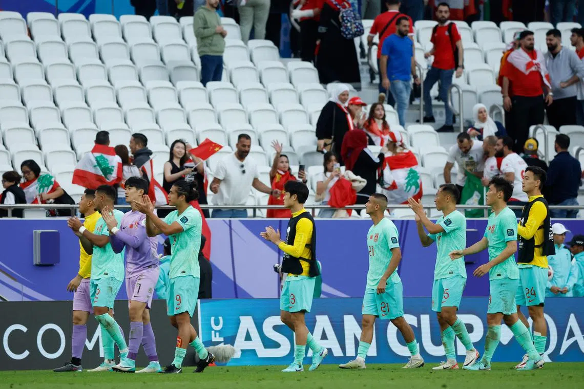 China's players greeting their fans after the Asian Cup Group A football match between Lebanon and China at the Al-Thumama Stadium in Doha on Jan 17 that ended 0-0.