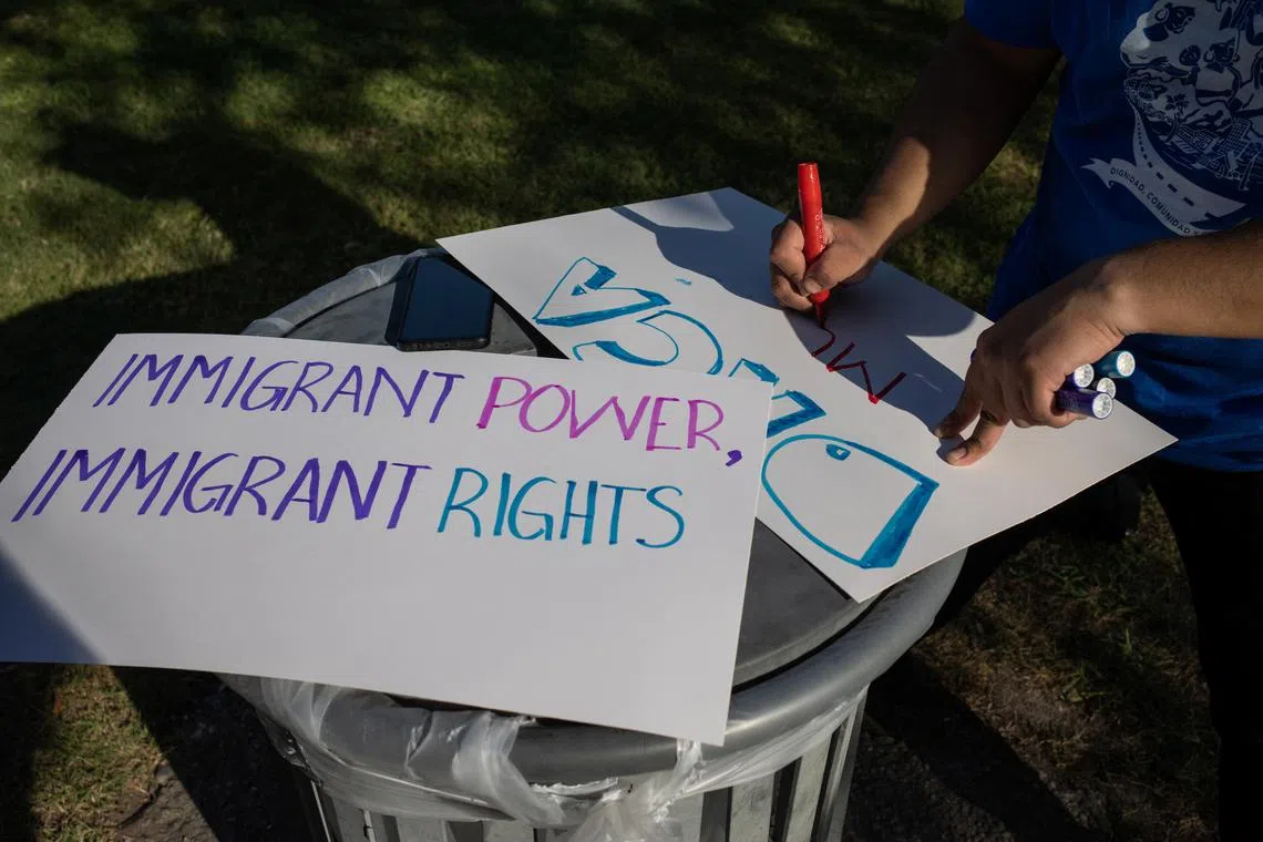 FILE PHOTO: Activists draw placards in support of the Deferred Action for Childhood Arrivals policy ahead of a hearing on a revised version of the DACA program outside a federal courthouse in Houston, Texas, U.S., June 1, 2023. REUTERS/Adrees Latif/File Photo