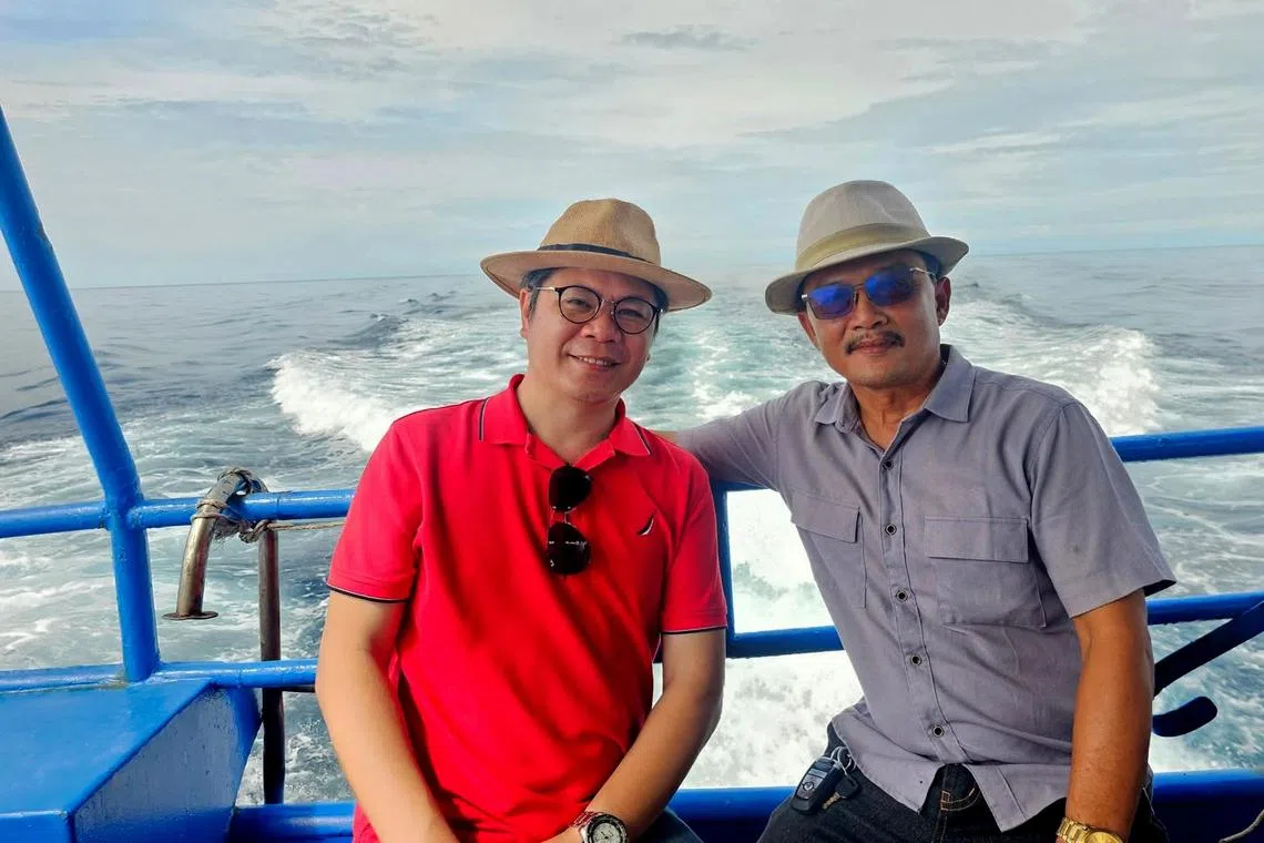 Dr Huy Nguyen (left), a university lecturer in Hanoi and well-known climate change scientist who has been providing weather and disaster predictions for 15 years, with tour boat owner Tran Cong Nam.