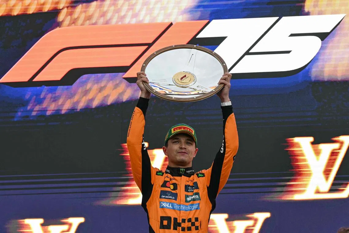 McLaren's Lando Norris celebrates after winning the 2025 season-opening Australian Grand Prix.