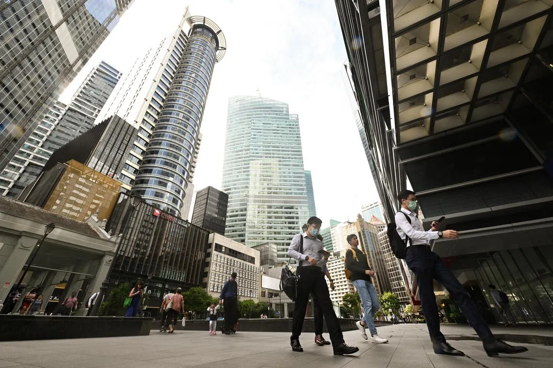 Office workers walking at Raffles Place Park within the heart of Singapore's financial centre in the CBD area on Mar 2, 2023. Can be used for stories on money, population, property, land, commercial, office, invest, budget, income, bank, finance, financial, CBD, URA, population, economy, and development.