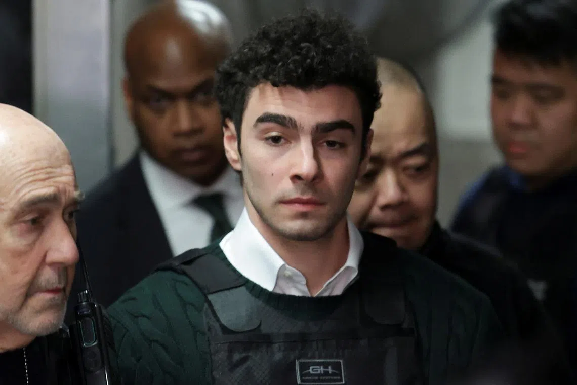 Luigi Mangione, the suspect in the killing of UnitedHealth Group chief executive Brian Thompson, arrives for a hearing in Manhattan Criminal Court on New York state murder and terrorism charges in New York City, U.S., February 21, 2025. REUTERS/Jeenah Moon