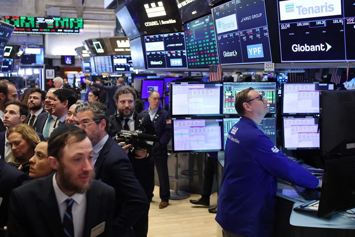 Traders work on the floor of the New York Stock Exchange, in New York City.