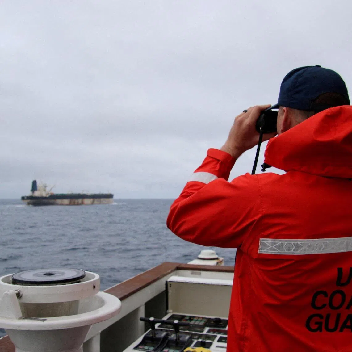A US Coast Guard official looking through binoculars at the Marinera (formerly Bella 1), which was seized by the US on Jan 7, after a more than two-week-long pursuit across the Atlantic.