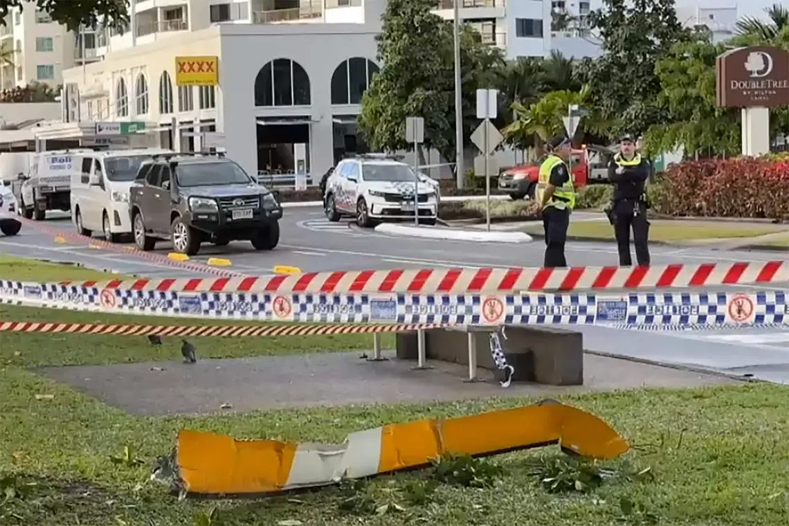 A piece of the helicopter lying on a roadside after a helicopter crashed into the roof of a Hilton hotel in Cairns. 