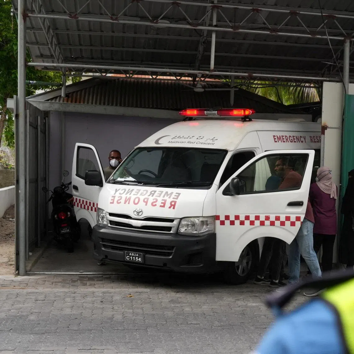 An ambulance carrying the body of one of the five Italian scuba divers who died in an accident in underwater caves, arrives at a mortuary in Male, Maldives, May 19, 2026. REUTERS/Thilina Kaluthotage