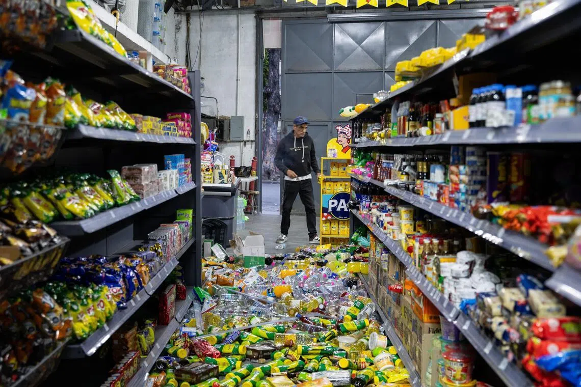 epa13062570 A person looks at spilled groceries at a warehouse in Caracas, Venezuela, 24 June 2026. Two powerful earthquakes struck Venezuela, including a magnitude 7.5 earthquake, causing buildings to collapse as authorities assessed damage and possible casualties, according to the US Geological Survey (USGS) and local officials.  EPA/RAYNER PENA