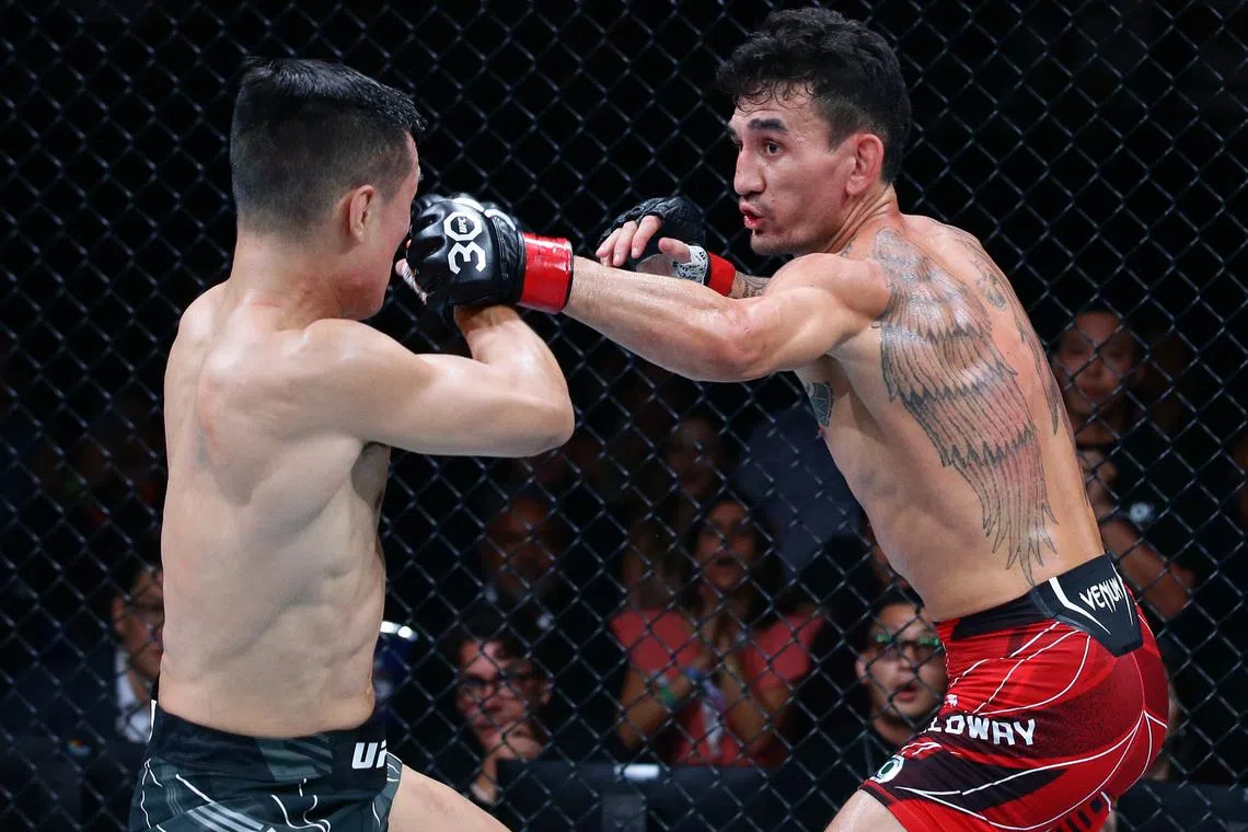 SINGAPORE, SINGAPORE - AUGUST 26: (R-L) Max Holloway punches Chan Sung Jung of South Korea in a featherweight bout during the UFC Fight Night event at Singapore Indoor Stadium on August 26, 2023 in Singapore. (Photo by Suhaimi Abdullah/Zuffa LLC via Getty Images)