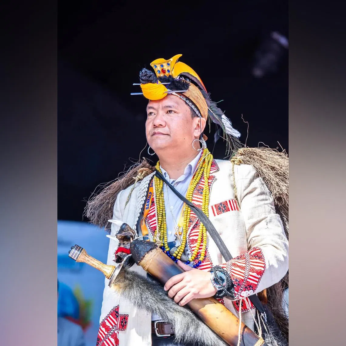 Arunachal Pradesh Chief Minister Pema Khandu wearing 3D printed hornbill beak on his headgear and a tiger jaw attached to the strap of a traditional machete.
