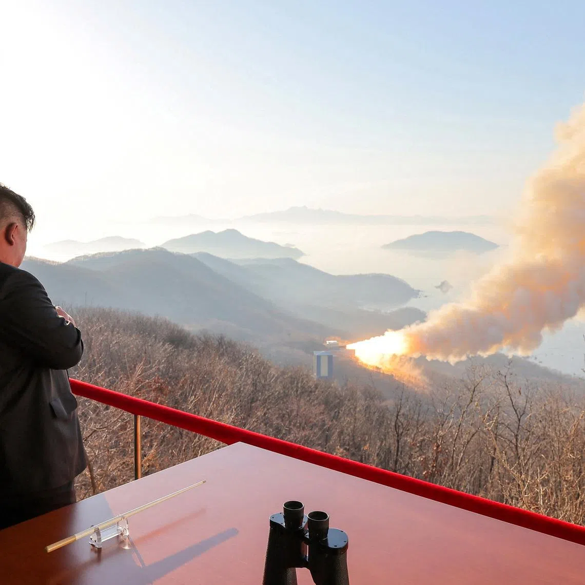 North Korea's Kim Jong Un observes a ground ejection test of what KCNA says is a high-output solid-fuel engine using carbon fiber composite materials.