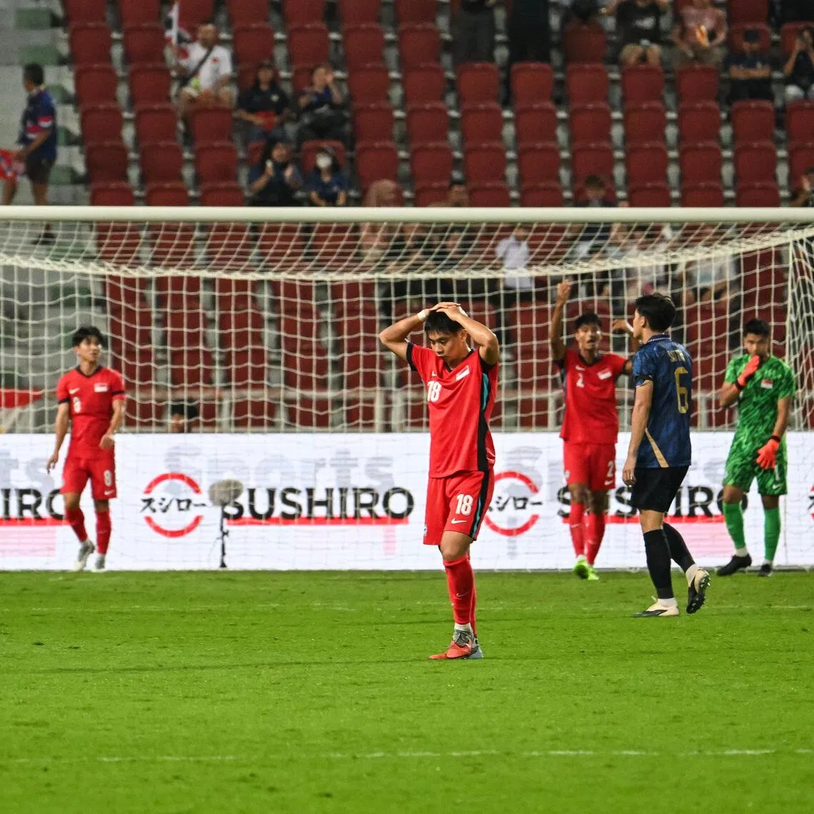 Singapore's Under-22 players react after a missed chance against Thailand  at the Rajamangala National Stadium in Bangkok, Thailand, on Dec 11, 2025.