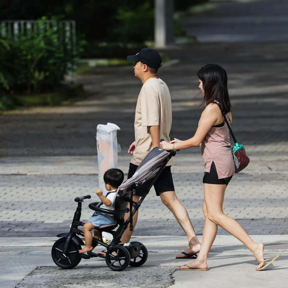 Addressing Singapore’s existential challenge of falling birth rates may require rethinking how society shares the cost of raising children, says the writer. 