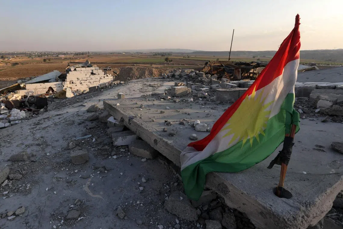 A Kurdish flag is pictured amid the destruction caused by a reported Iranian rocket attack near town city of Altun Kupri (Perdi), north of Kirkuk, in Iraq's autonomous Kurdistan region, on November 23, 2022. - Iran's Foreign Minister Hossein Amir-Abdollahian warned today that Tehran would continue to act against "threats" from abroad, following a series of Iranian cross-border strikes on Kurdish opposition groups based in Iraq. (Photo by SAFIN HAMED / AFP)