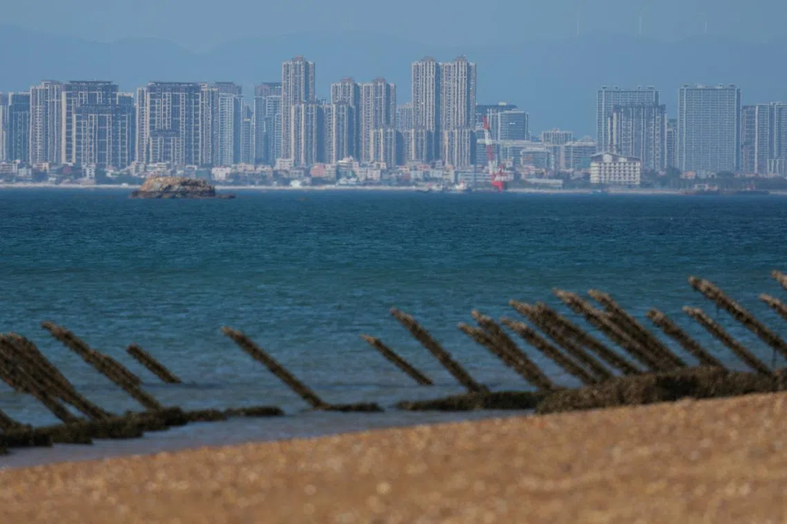 FILE PHOTO: Anti-landing barricades are pictured on the beach, with China's Xiamen city in the background, in Kinmen, Taiwan February 21, 2024. REUTERS/Ann Wang/File Photo