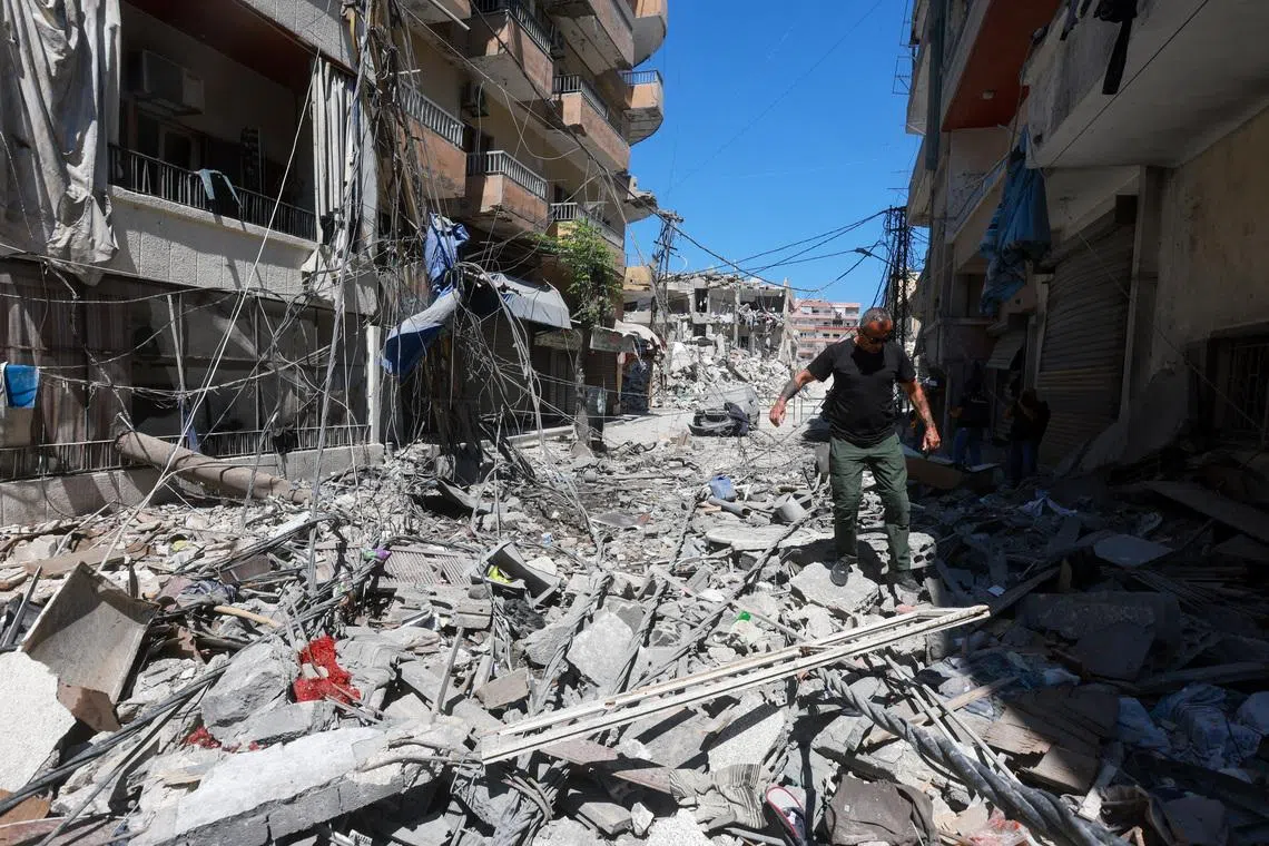 A man walks on rubble at the site an Israeli strike in Tyre, Lebanon, June 12, 2026. REUTERS/Aziz Taher