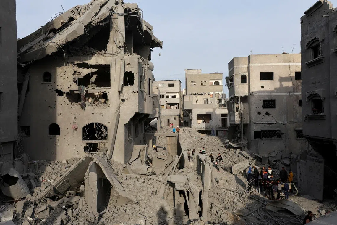 Palestinians inspect damage at the site of an Israeli strike on a house, amid the Israel-Hamas conflict, at the Nuseirat refugee camp in the central Gaza Strip, December 7, 2024. REUTERS/Ramadan Abed/File Photo
