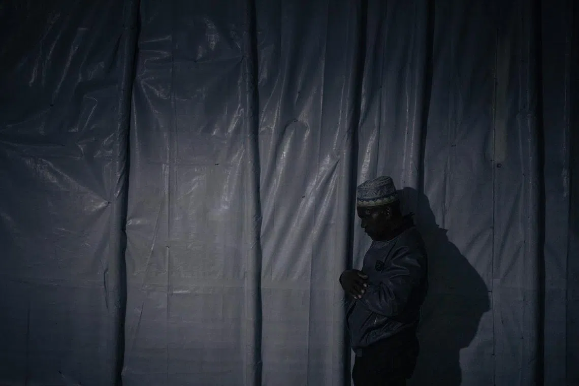 A displaced Muslim in prayer before breaking the Ramadan fast at nightfall at an informal displacement camp in Goma, eastern Democratic Republic of Congo, March 27.