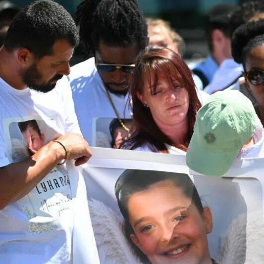 Lyhanna's father and mother Martial Bernard (left) and Charly Rameau (third from left) taking part in a silent march in tribute to Lyhanna on June 7 in Fleurance, south-western France.