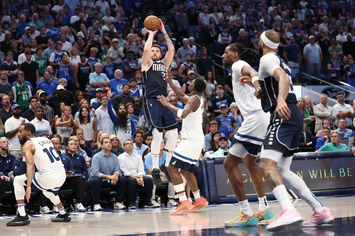 Dallas Mavericks guard Luka Doncic shoots over Minnesota Timberwolves guard Anthony Edwards during the fourth quarter of Game 4 of the NBA Western Conference Finals.