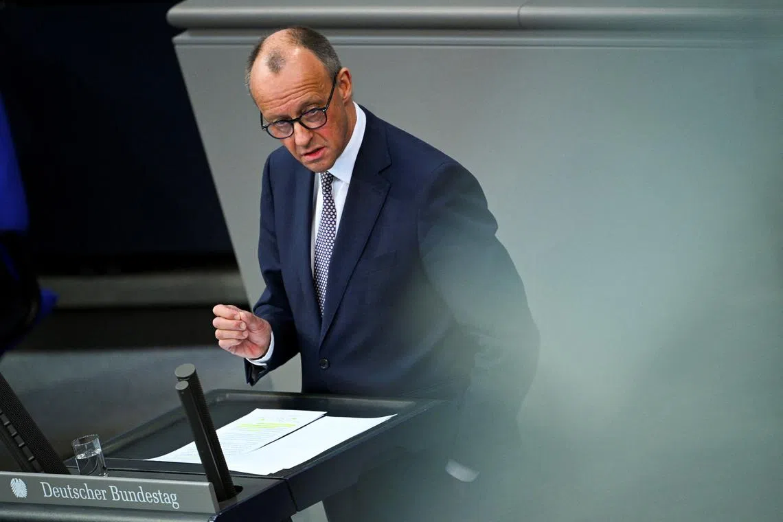 German Chancellor-in-waiting Friedrich Merz speaks during an extraordinary session of the outgoing lower house of parliament, the Bundestag, for a vote to adopt the draft law brought by the SPD and CDU/CSU parliamentary groups to reform constitutional debt rules and set up a 500 billion euro infrastructure fund, in Berlin, Germany March 18, 2025. REUTERS/Annegret Hilse