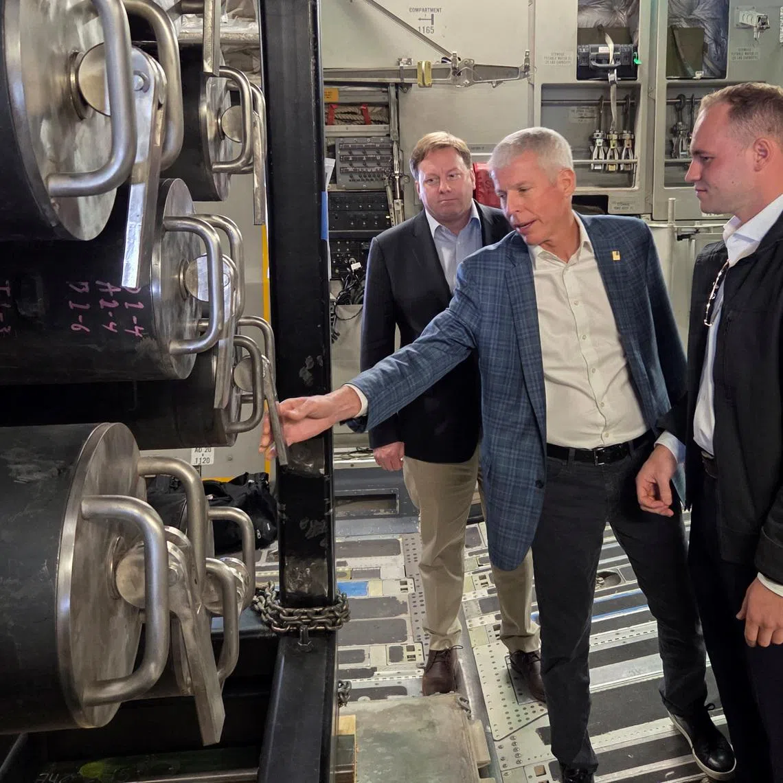 U.S. Energy Secretary Chris Wright and U.S. Under Secretary of Defense for Acquisition and Sustainment Michael Duffey on board a C-17 cargo plane that transported Valar Atomics' Ward nuclear microreactor from March Air Force Base in California to Hill Air Force Base in Utah, at the Hill Air Force Base in Utah, U.S., February 15, 2026. REUTERS/Valerie Volcovici