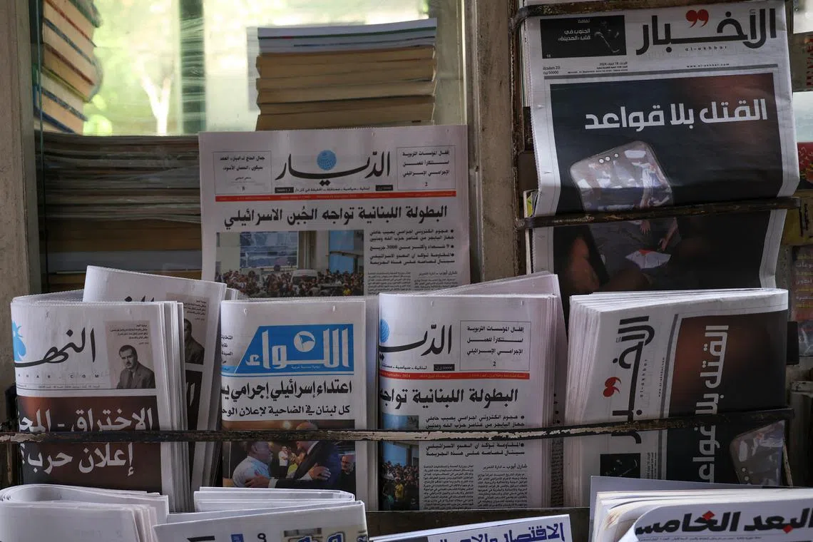 FILE PHOTO: A newsstand shows headlines following pager detonations across Lebanon on Tuesday, in Beirut, Lebanon September 18, 2024. REUTERS/Emilie Madi/File Photo