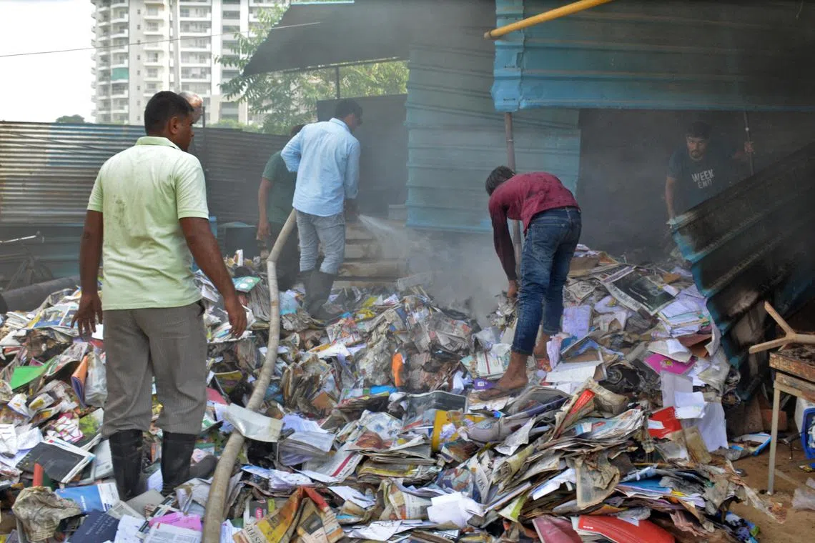 People search through the rubble of a scrap shop that was vandalised by a mob following clashes between Hindu and Muslims that erupted on Monday, in Gurugram, on the outskirts of New Delhi, India, August 1, 2023. REUTERS/Stringer NO RESALES. NO ARCHIVES
