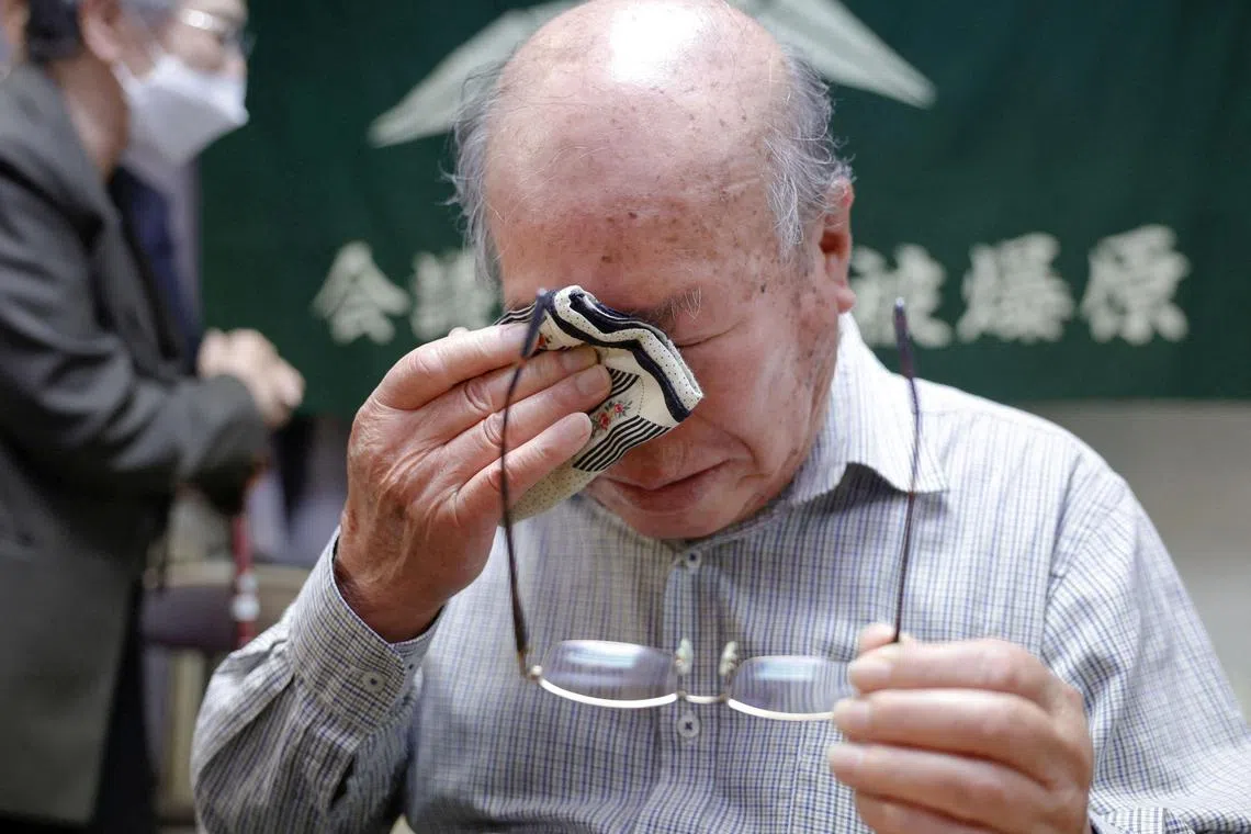 Shigemitsu Tanaka, a member of Japan Confederation of A- and H-Bomb Sufferers Organizations (Nihon Hidankyo), who survived the 1945 atomic bombing of Nagasaki, cries after the 2024 Nobel Peace Prize winner was announced in Nagasaki, Japan October 11, 2024, in this photo taken by Kyodo. Mandatory credit Kyodo/via REUTERS