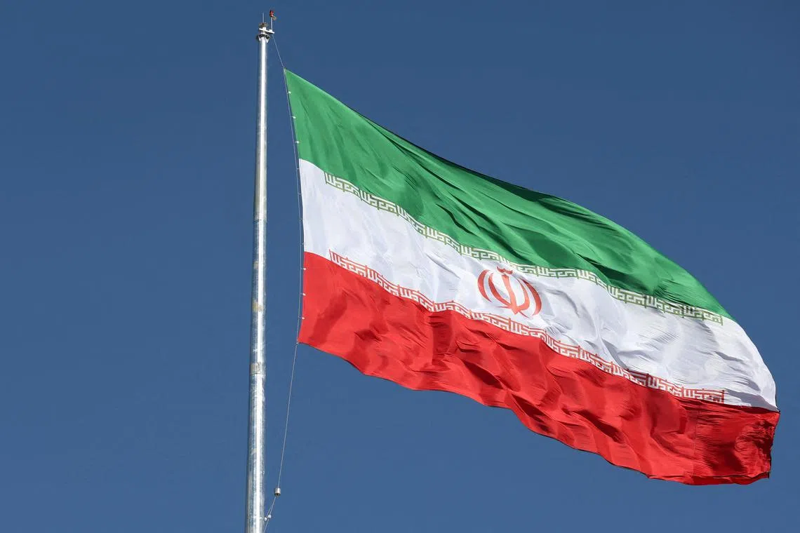 FILE PHOTO: The Iranian flag is seen flying over a street in Tehran, Iran, February 3, 2023. Majid Asgaripour/WANA (West Asia News Agency) via REUTERS /File Photo