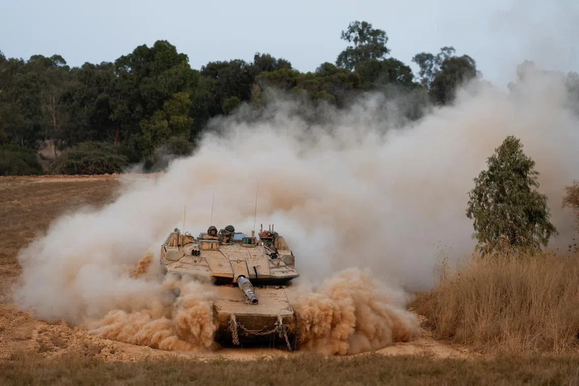 An Israeli tank maneuvers near the Israel-Gaza border before it enters Gaza, amid the Israel-Hamas conflict, as seen from Israel, July 4, 2024. REUTERS/Amir Cohen/File Photo