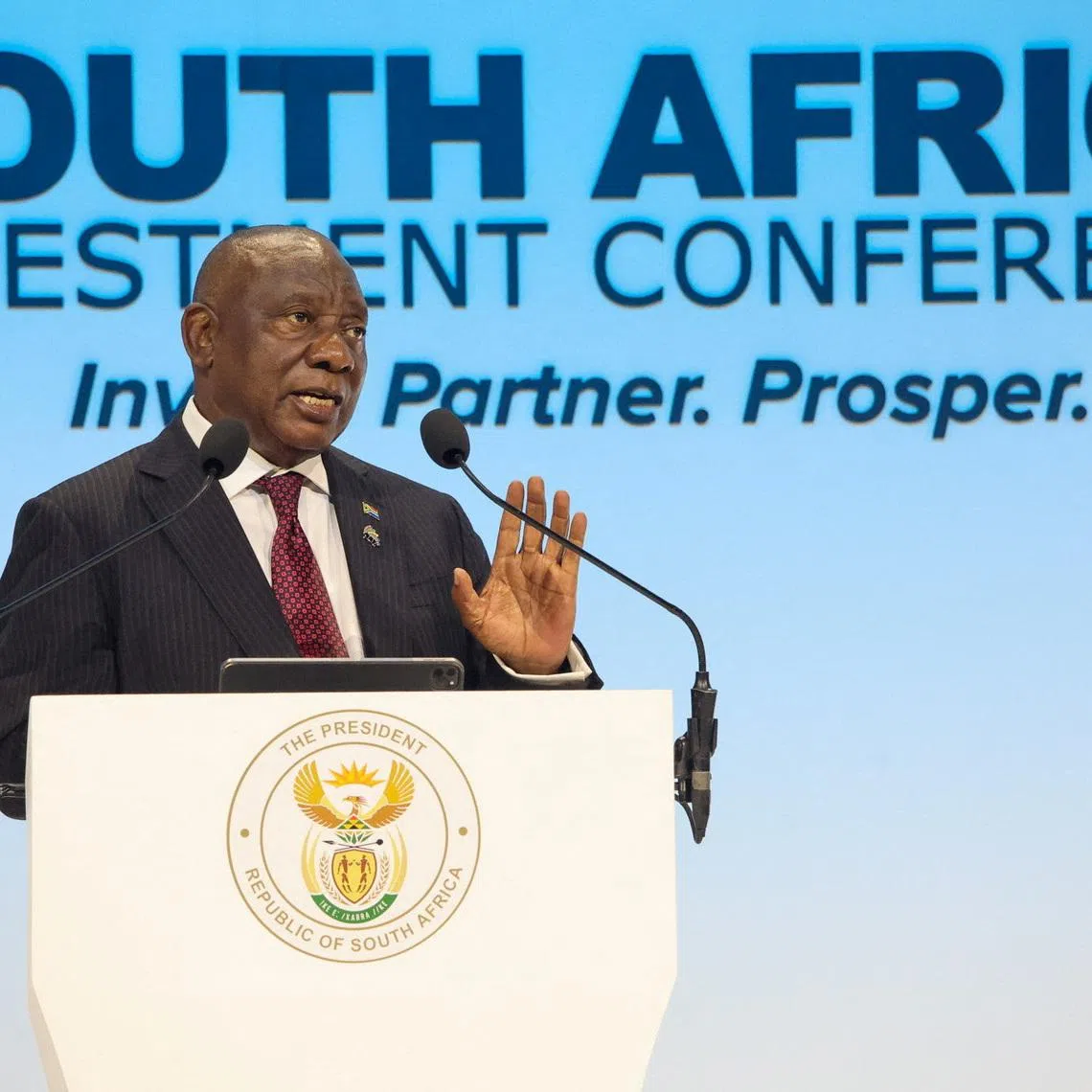 FILE PHOTO: South African President Cyril Ramaphosa gestures while delivering the keynote address at the Sixth South Africa Investment Conference (SAIC) at the Sandton Convention Centre in Johannesburg, South Africa. March 31, 2026. Jairus Mmutle/GCIS/Handout via REUTERS/File Photo