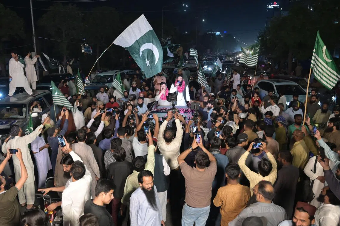 Pakistanis hold a rally to show solidarity with the Pakistani military on April 12.