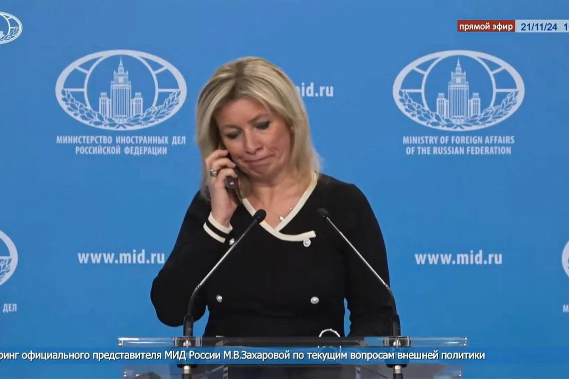 A TV grab shows Russian foreign ministry spokeswoman Maria Zakharova receiving a phone call during a live press briefing on Nov 21, telling her not to comment on reports of a ballistic missile strike on Ukraine.