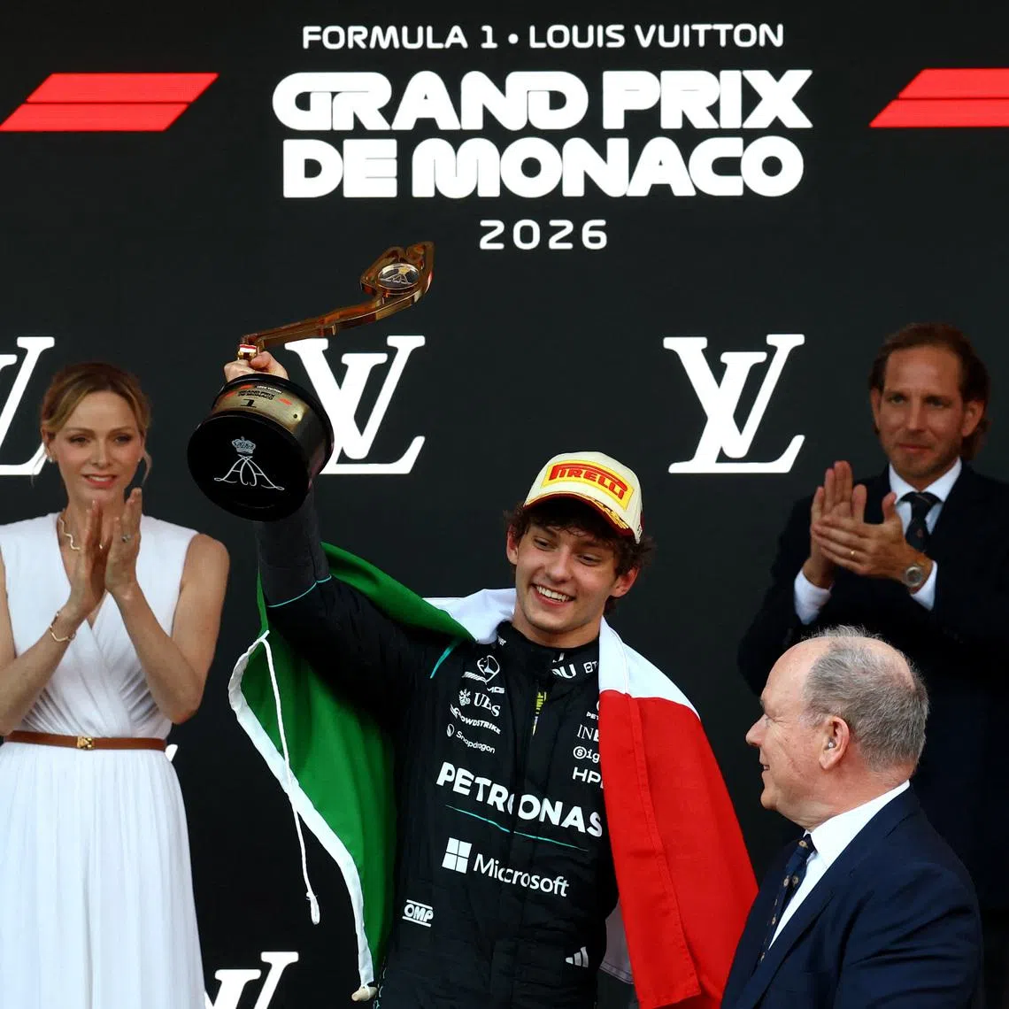 Mercedes' Andrea Kimi Antonelli celebrates with the trophy on the podium after winning the Monaco Grand Prix.