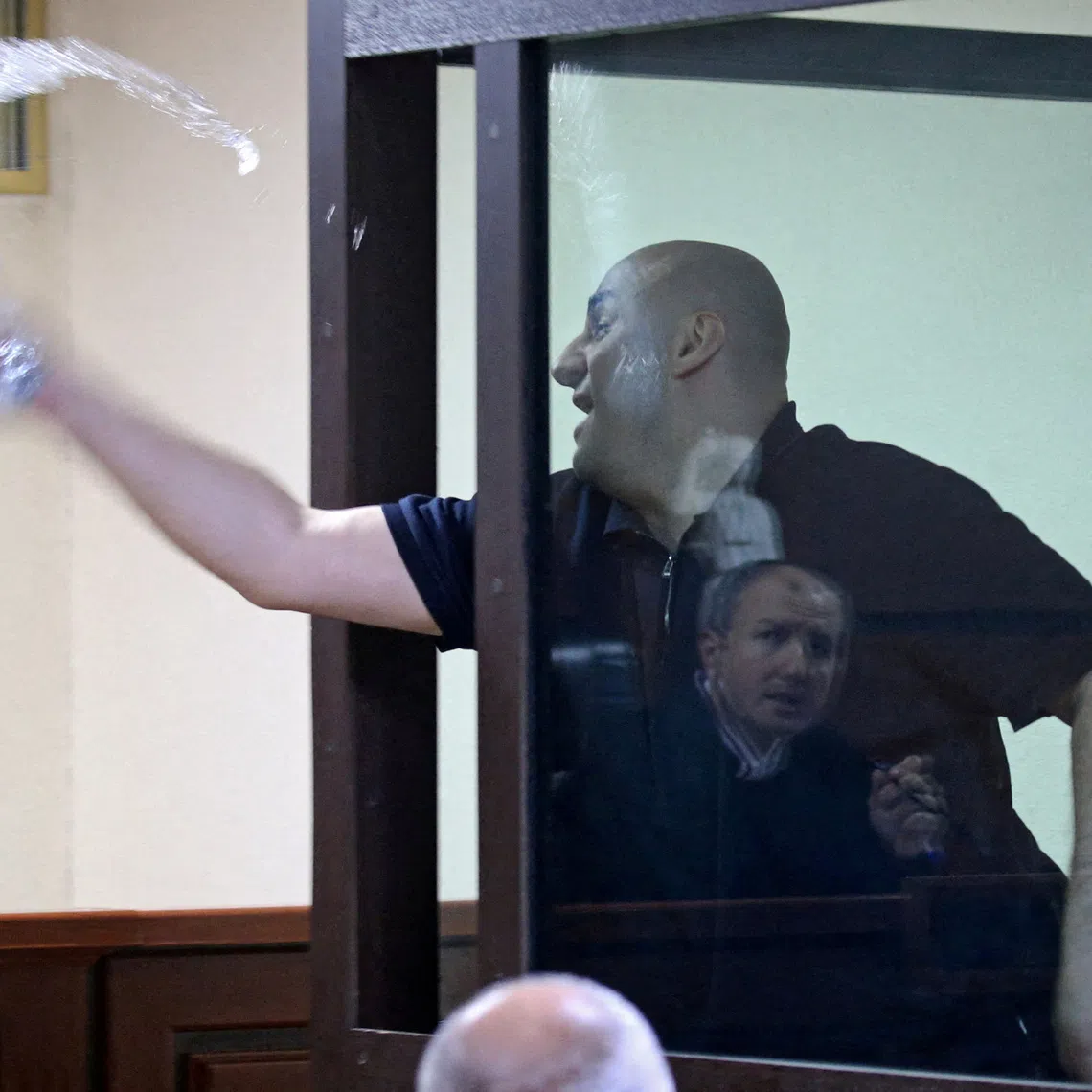 FILE PHOTO: Nika Melia, one of the leaders of the Coalition for Change opposition group, charged with failing to appear before the Georgian parliament's temporary investigative commission, splashes water towards a judge during a court hearing in Tbilisi, Georgia May 30, 2025. REUTERS/Irakli Gedenidze/Pool/File Photo