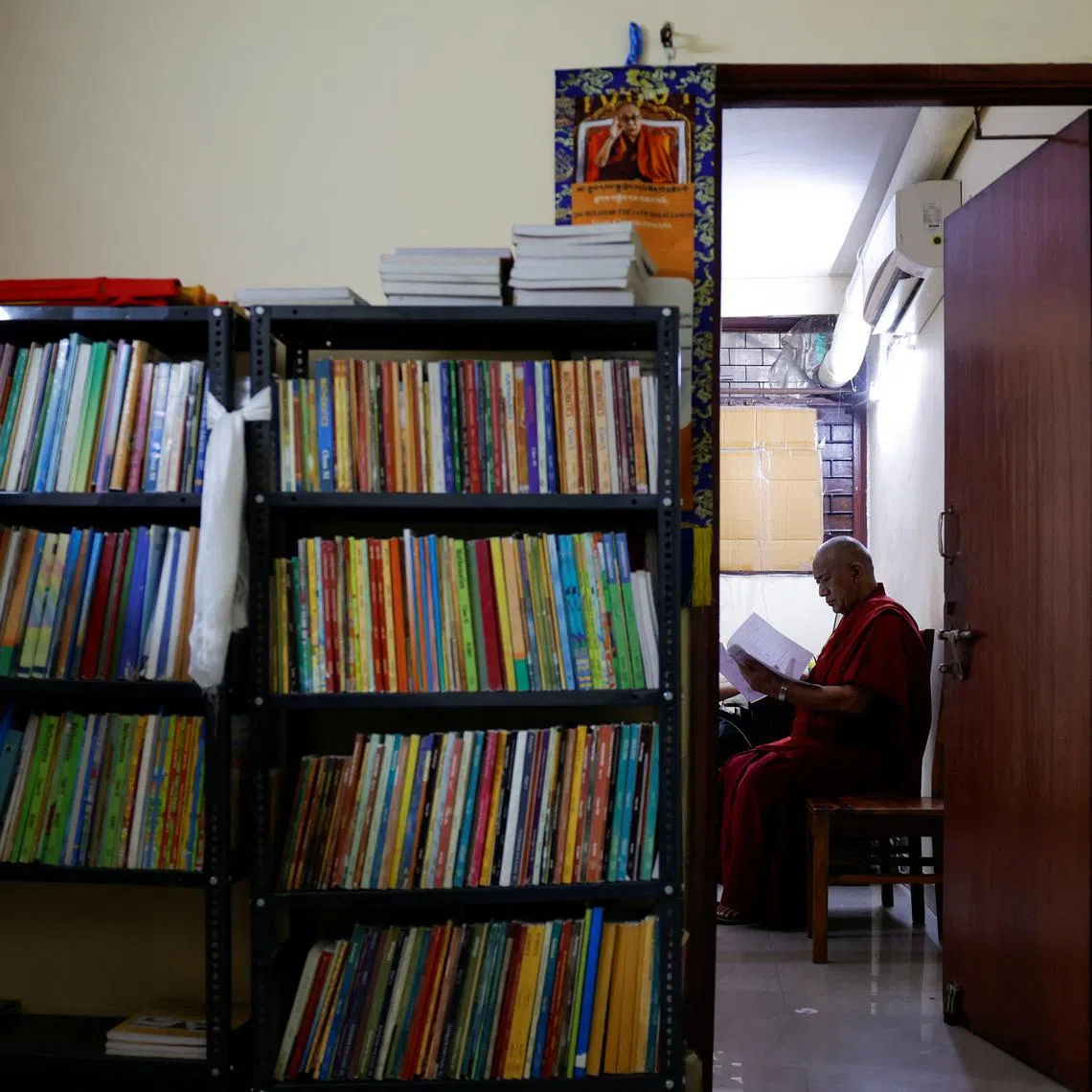 Lama Chosphel Zotpa, a monk and vice president of Indian Himalayan Council of Nalanda Buddhist Tradition (IHCNBT) reads a document at its office in New Delhi, India, March 13, 2025. REUTERS/Anushree Fadnavis