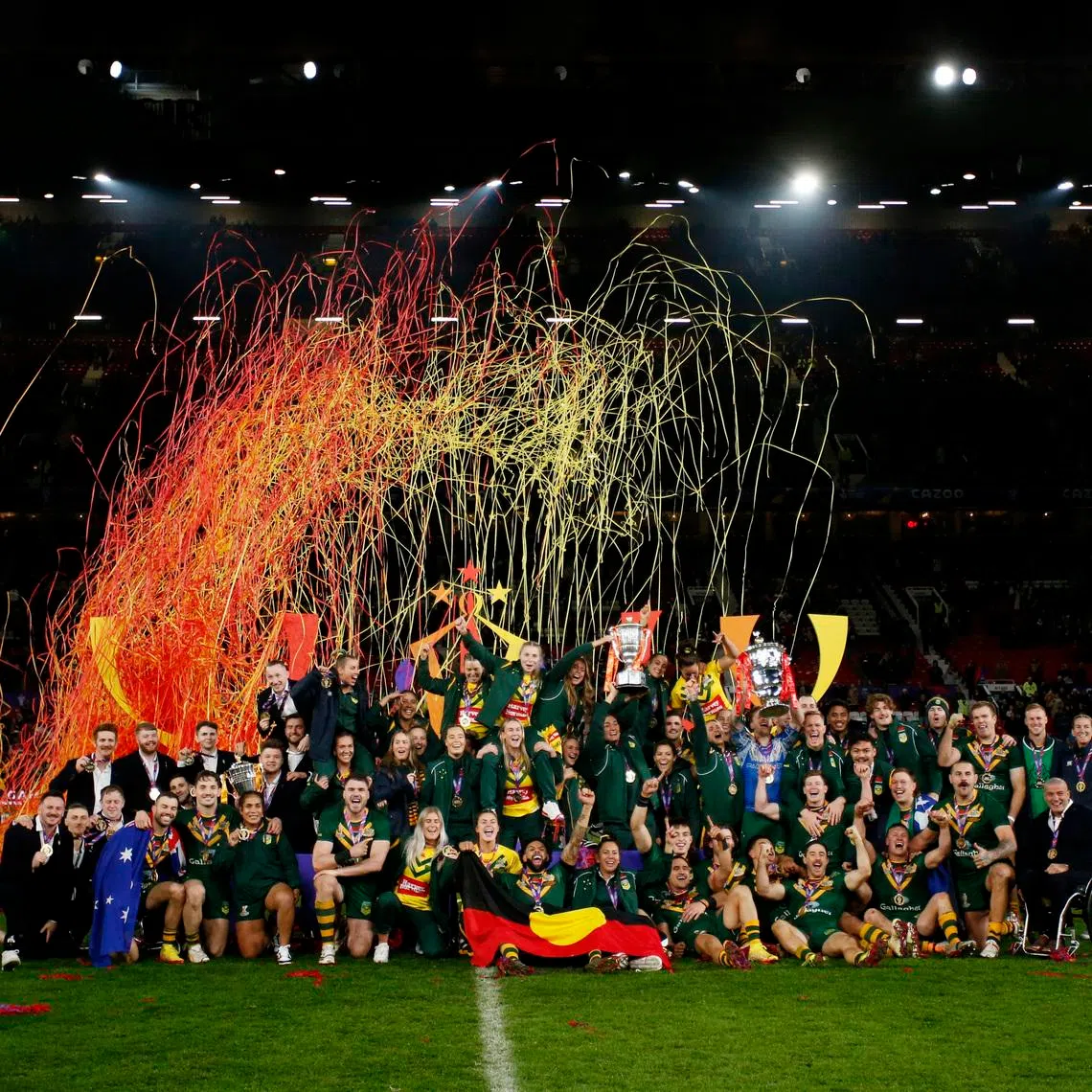 Rugby League - Men's World Cup Final - Australia v Samoa - Old Trafford, Manchester, Britain - November 19, 2022 Australia's men's and women's teams celebrate with their trophies after winning the world cup finals Action Images via Reuters/Ed Sykes