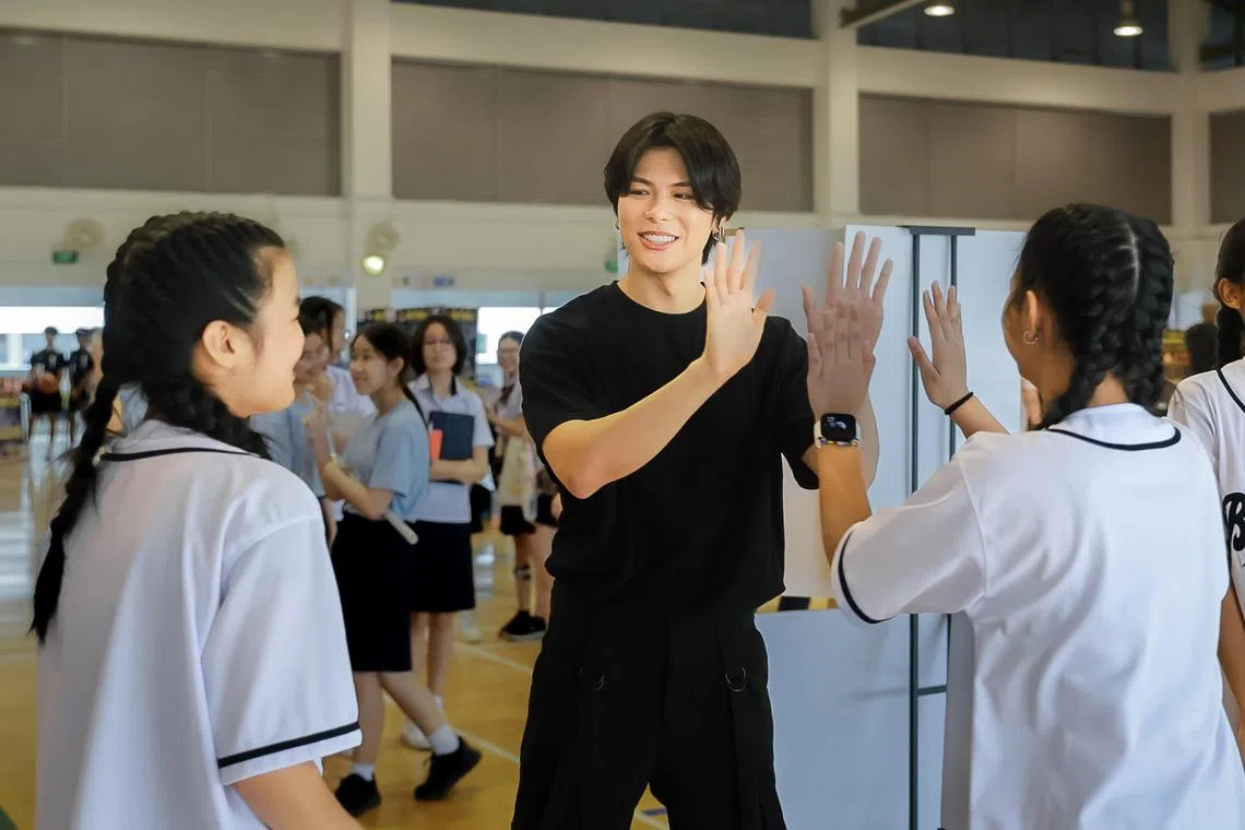 Actor Glenn Yong visiting his alma mater Peicai Secondary School and interacting with students during its open house for PSLE pupils, Nov 25, 2023.